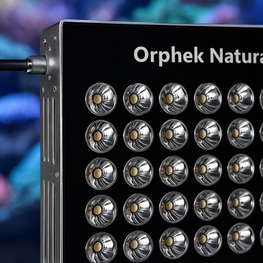 A detailed close-up of the Orphek Natura iCon LED unit, focusing on its reflector and LED components, with a blurred coral reef in the background, emphasizing the product's technological features and build quality.